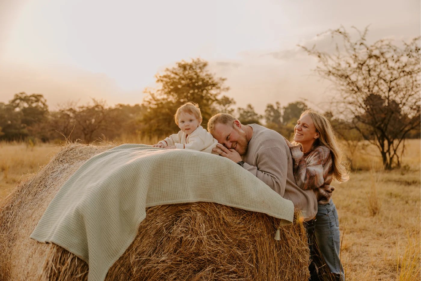 Hansie en Grietjie founders with their daughter, in a field at golden hour
